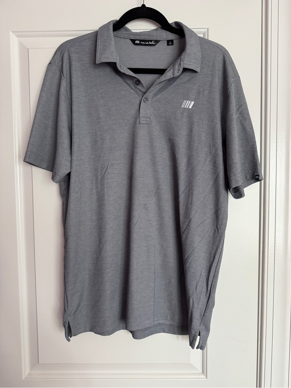 grey NASCAR TravisMathew branded polo shirt